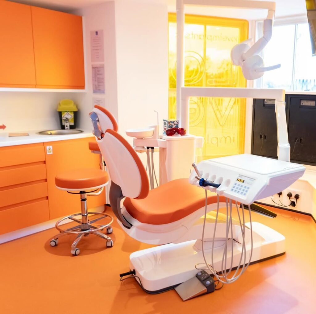 Bright orange and white dental treatment room at the Love Implants practice in Colchester