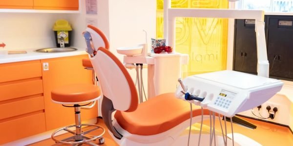 Bright orange and white dental treatment room at the Love Implants practice in Colchester